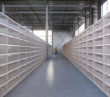 Bright interior aisle fitted with uniform white metal frameworks