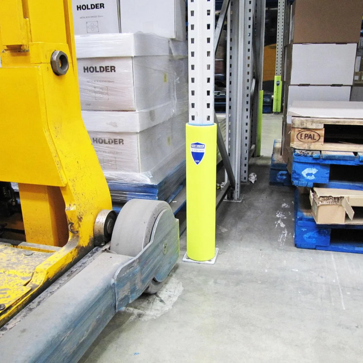 pallet rack upright guards in warehouse aisle