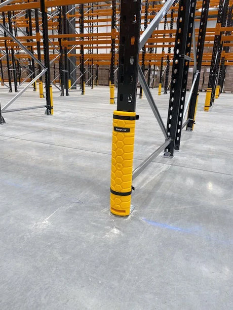 High-visibility upright protection installed in warehouse racking aisle