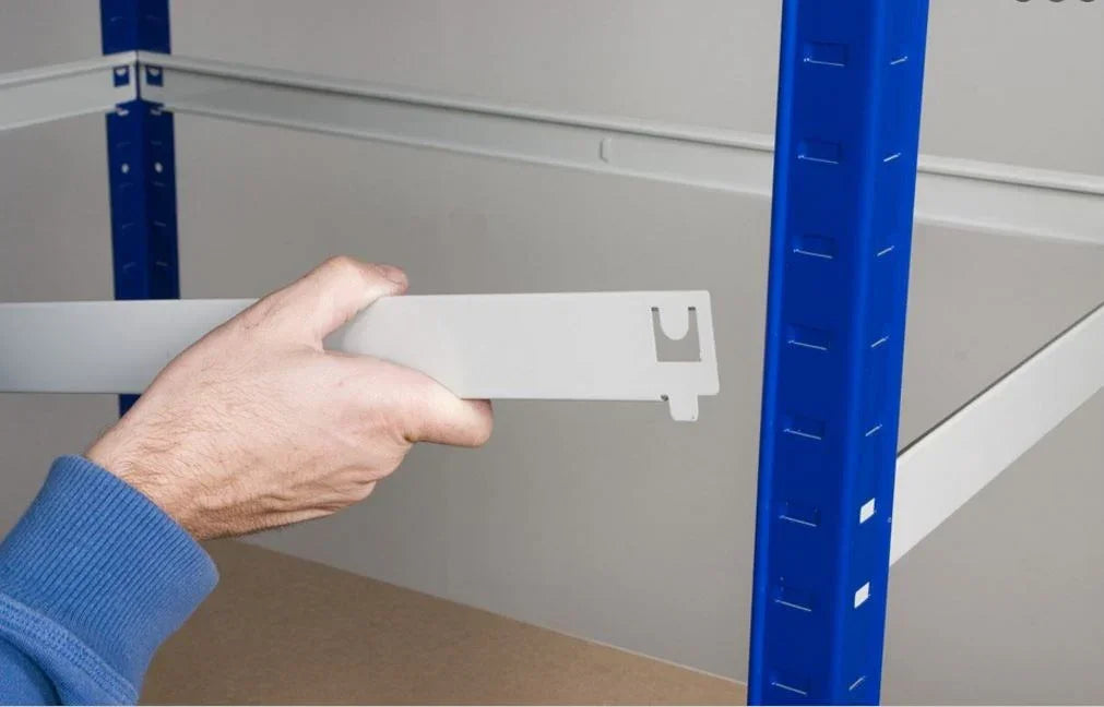MDF shelf being positioned onto steel frame during assembly